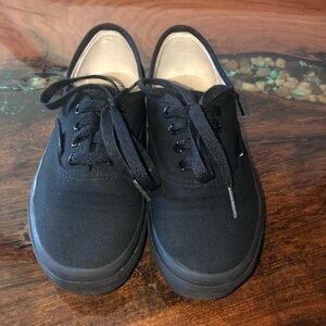 Vans all black kids lace up skateboard shoes.